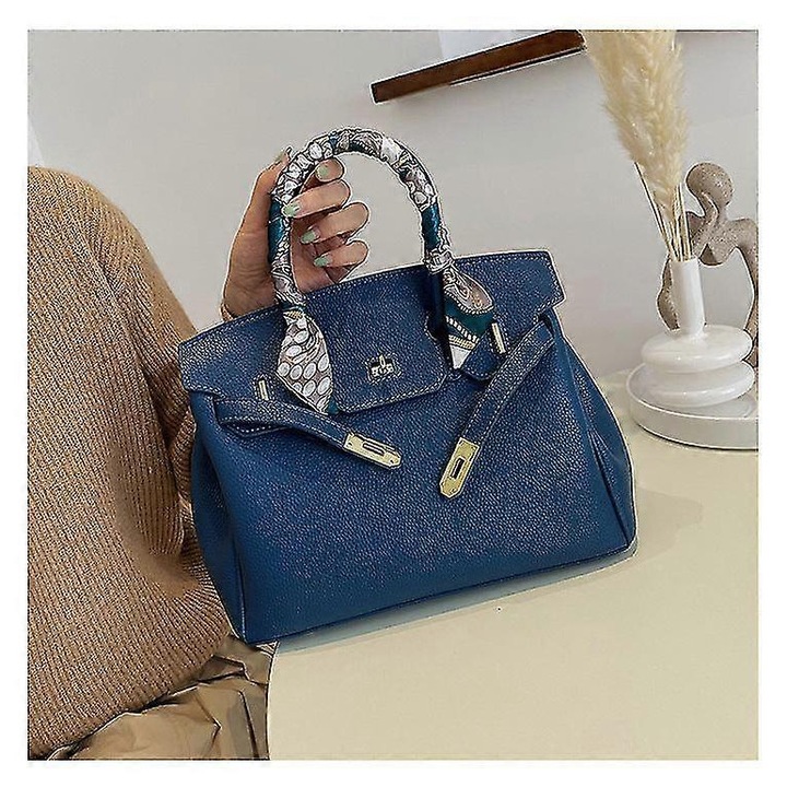 Női táska, vintage modell, sötétkék színű, közepes méretű, négyzet alakú, telefon- és dokumentumtartó rekeszekkel.