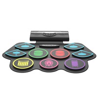 Set tobe electronice MaGeCa® cu pedale de picior, Design compact si portabil, 9 Pad-uri de tobe colorate, Difuzor dublu incorporat, Silicon 100% rezistent la apa, Negru