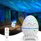 Proiector Stele Ou de Dinozaur 4 IN 1, Lampa veghe copii, Speaker Bluetooth, LED, 19 Sunete Albe, Rotatie 360°, 14 Proiectii si Culori cu 4 Luminozitati cu Telecomanda, Functie de Cronometru, Wireless, Alb