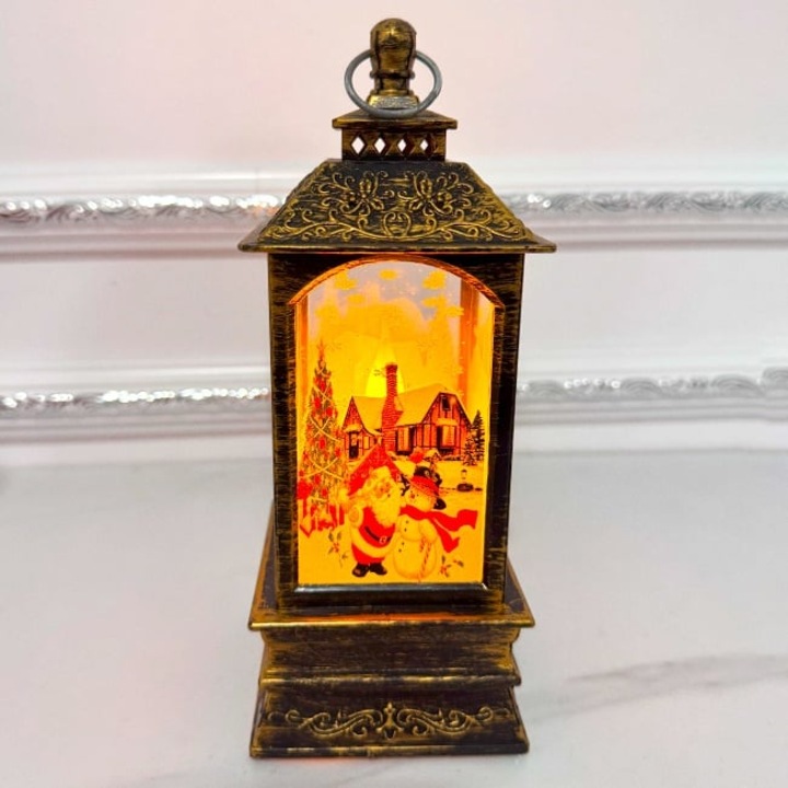 Felinar luminos decorativ Light and Magic, cu LED si peisaj de iarna, Mos Craciun cu Om de Zapada, Maro, 21X8X8 cm, Velve