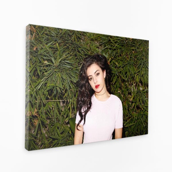 Картина на платно - Момиче с червени устни, розова риза, храсти зад нея - 40x60 cm