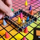 Joc de societate Hues and Cues, Noonedibs, Pentru 3-10 jucatori, de la 8 ani in sus, conecteaza indicii si ghiceste din 480 de patrate colorate