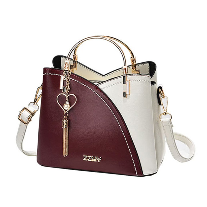 Női táska, vállpánttal és két fix fogantyúval, sok rekesszel és szív medállal, öko bőr, sötétpiros/fehér